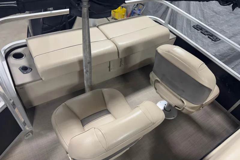 Slide: The Image of 2020 Sun Tracker SportFish 22 XP3 boat interior with beige seating and cup holders. - 15