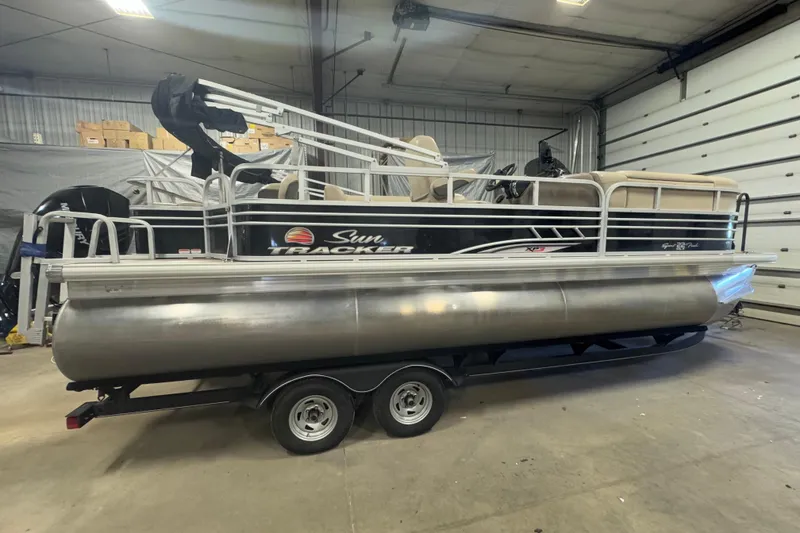 Slide: The Image of 2020 Sun Tracker SportFish 22 XP3 pontoon boat in a garage setting. - 3