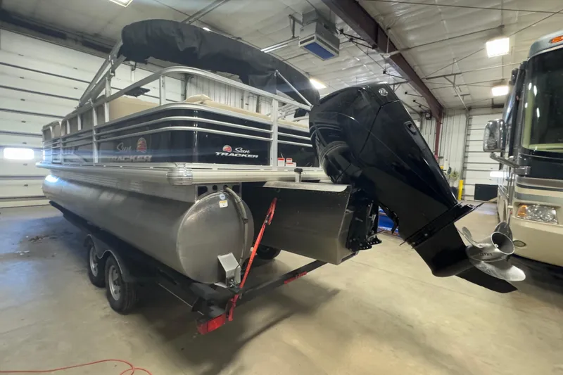 Slide: The Image of 2020 Sun Tracker SportFish 22 XP3 pontoon boat in indoor storage facility. - 5