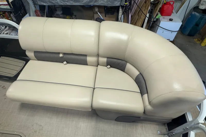 Slide: The Image of Beige seating on 2020 Sun Tracker SportFish 22 XP3 pontoon boat, in a garage setting. - 7