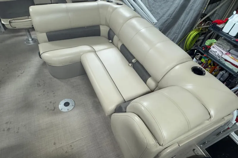 Slide: The Image of 2020 Sun Tracker SportFish 22 XP3 boat interior with beige seating and cup holders. - 9