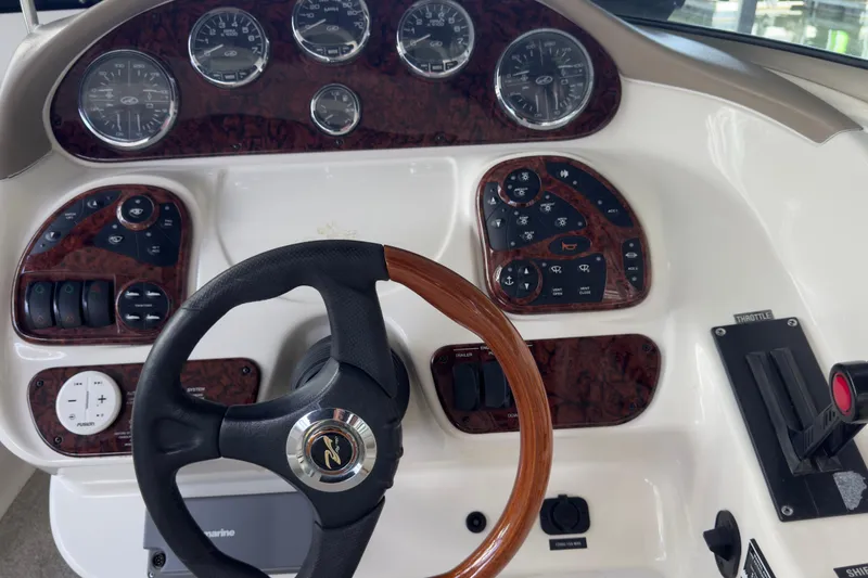 Slide: The Image of Dashboard of 2003 Sea Ray 290 Bowrider with steering wheel and control panels. - 11