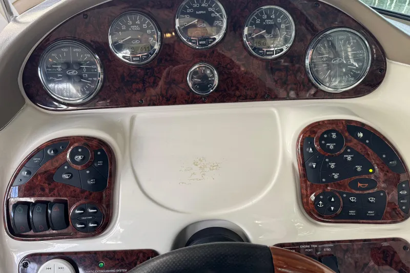 Slide: The Image of Dashboard of a 2003 Sea Ray 290 Bowrider boat with gauges and controls. - 12