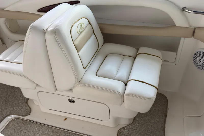 Slide: The Image of 2003 Sea Ray 290 Bowrider interior seating with white upholstery and storage compartment. - 14