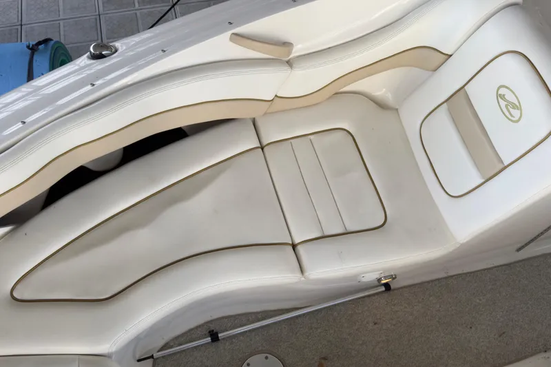 Slide: The Image of 2003 Sea Ray 290 Bowrider interior seating with white upholstery and elegant design. - 18