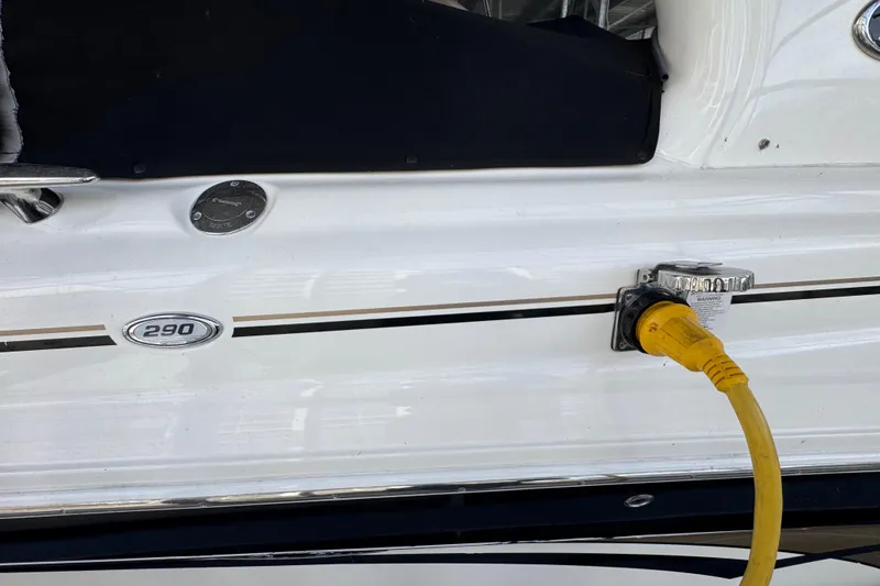 Slide: The Image of 2003 Sea Ray 290 Bowrider with yellow power cable connected to the side. - 24