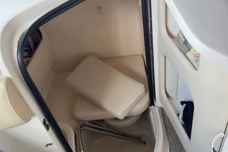 Slide: The Image of 2003 Sea Ray 290 Bowrider interior cabin with seating and storage. - 25