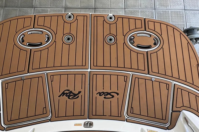 Slide: The Image of 2003 Sea Ray 290 Bowrider swim platform with teak-style decking and logo. - 26