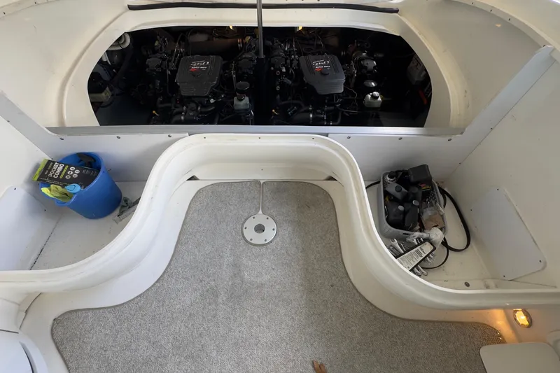 Slide: The Image of 2003 Sea Ray 290 Bowrider engine compartment with maintenance supplies and tools. - 31