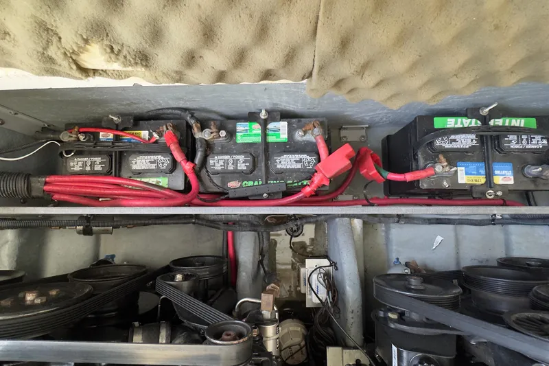 Slide: The Image of Battery compartment of a 2003 Sea Ray 290 Bowrider with visible wiring and components. - 33