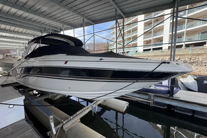 Slide: The Image of 2003 Sea Ray 290 Bowrider docked under a covered marina. - 4