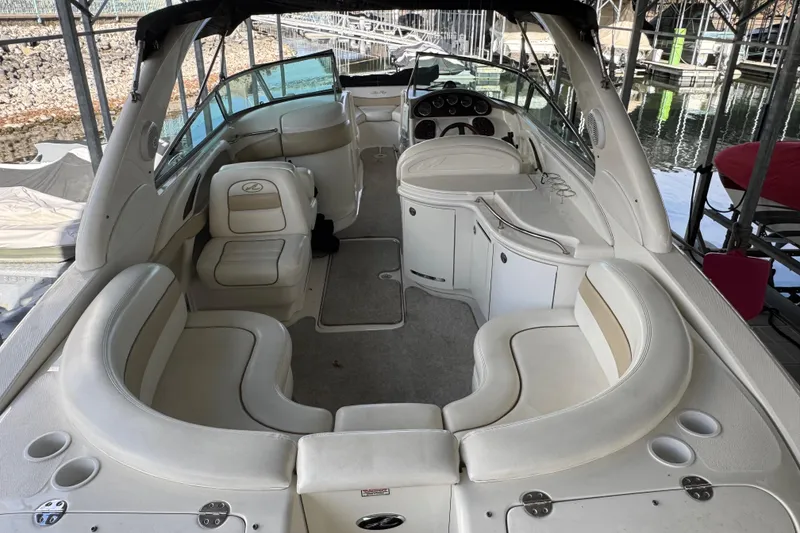 Slide: The Image of 2003 Sea Ray 290 Bowrider interior with spacious seating and helm, docked at marina. - 5