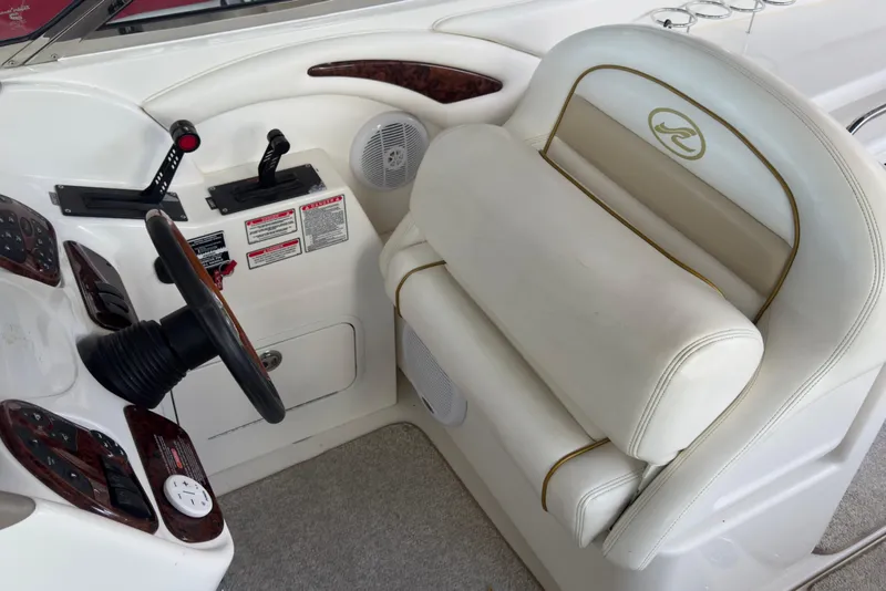 Slide: The Image of 2003 Sea Ray 290 Bowrider helm with steering wheel and control panel. - 8