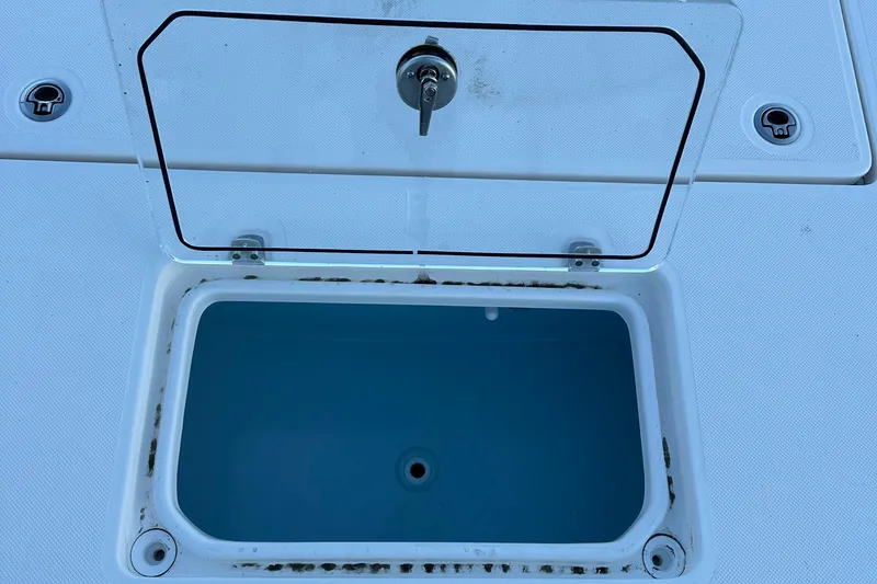 Slide: The Image of 2024 Sea Born FX 25 LE boat livewell with open lid, showcasing interior. - 2