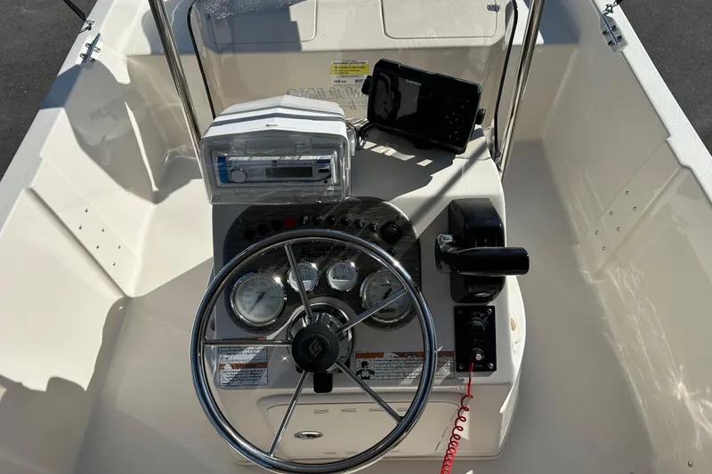 Slide: The Image of 2020 Carolina Skiff 162 JLS boat console with steering wheel and navigation equipment. - 10