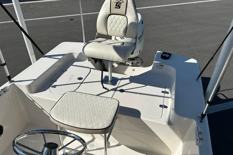 Slide: The Image of 2020 Carolina Skiff 162 JLS boat interior with seating and steering wheel. - 11