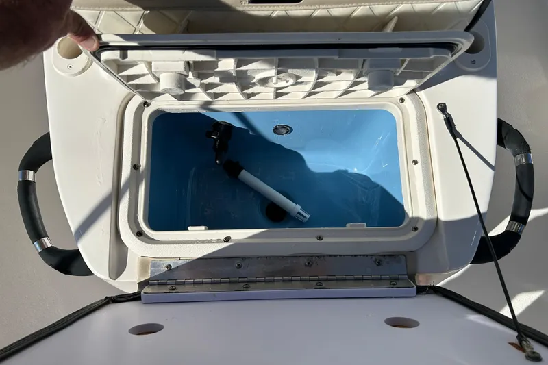 Slide: The Image of Open storage compartment on 2020 Carolina Skiff 162 JLS boat, showing interior details. - 14