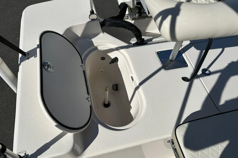 Slide: The Image of 2020 Carolina Skiff 162 JLS boat interior with open storage compartment and seating. - 15