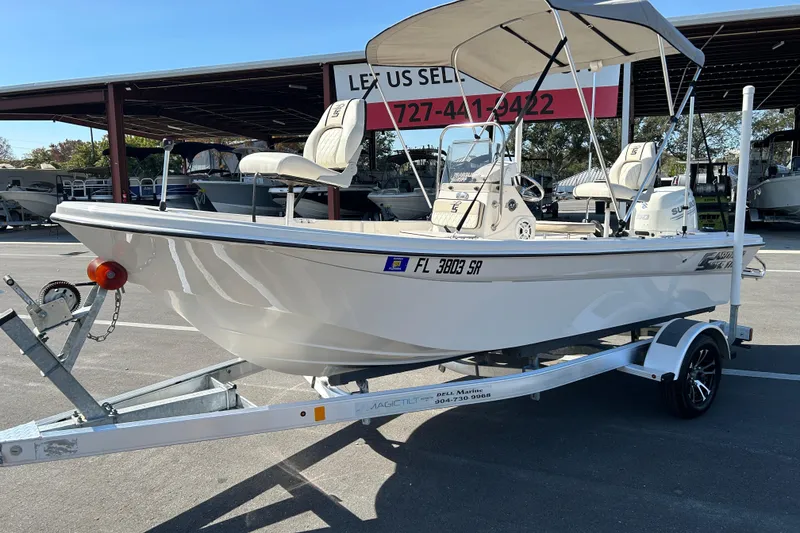 Slide: The Image of 2020 Carolina Skiff 162 JLS boat on trailer, parked outdoors under a canopy. - 5