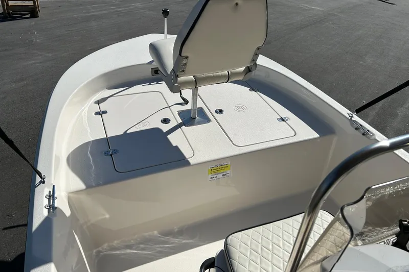 Slide: The Image of 2020 Carolina Skiff 162 JLS boat interior with seating and storage compartments. - 8