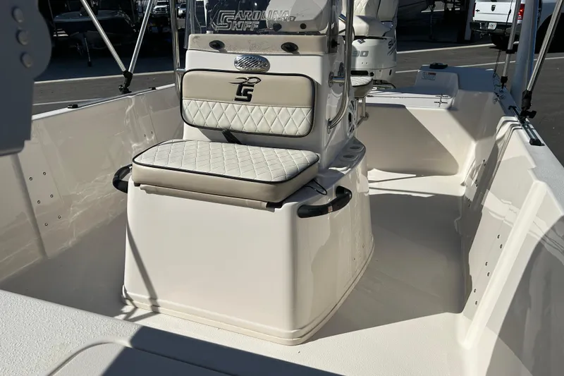 Slide: The Image of 2020 Carolina Skiff 162 JLS boat interior with cushioned seating and steering console. - 9