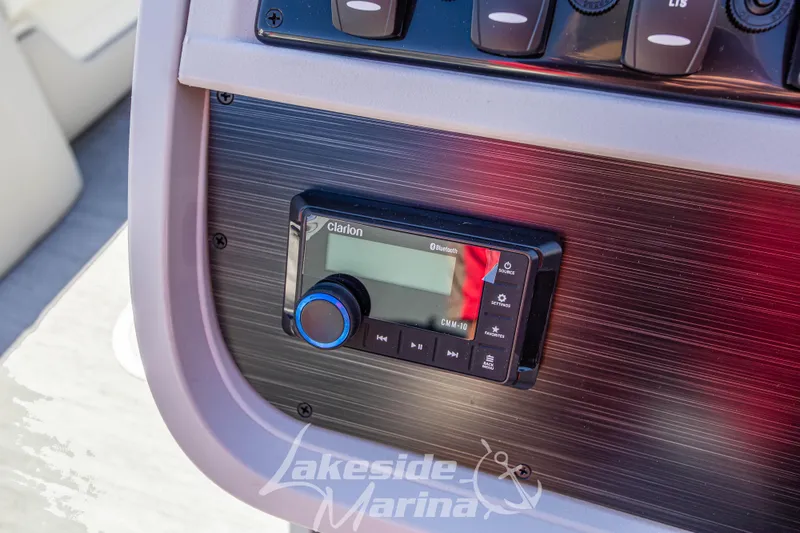 Slide: The Image of 2026 Godfrey Sweetwater 2286 SB boat dashboard with Clarion audio system. - 18