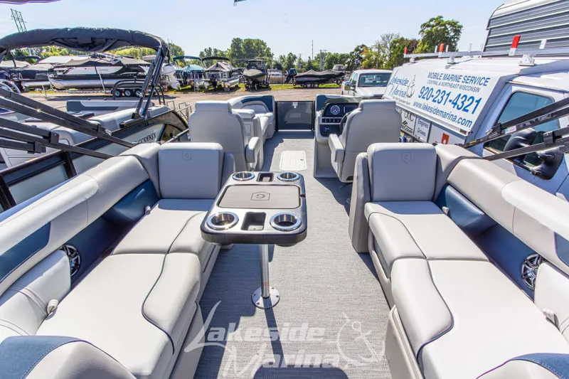 Slide: The Image of Interior of 2026 Godfrey Sweetwater 2286 SB pontoon boat with luxurious seating and table. - 22