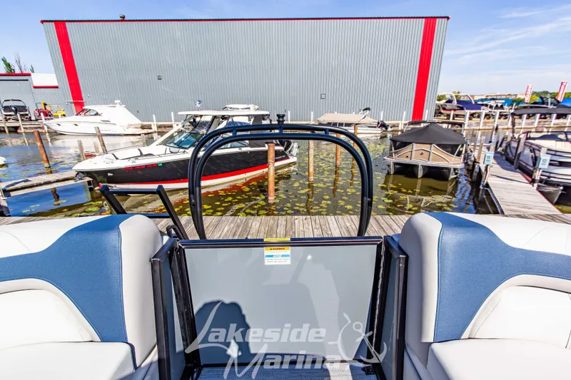 Slide: The Image of 2026 Godfrey Sweetwater 2286 SB pontoon boat at marina with docked boats. - 23