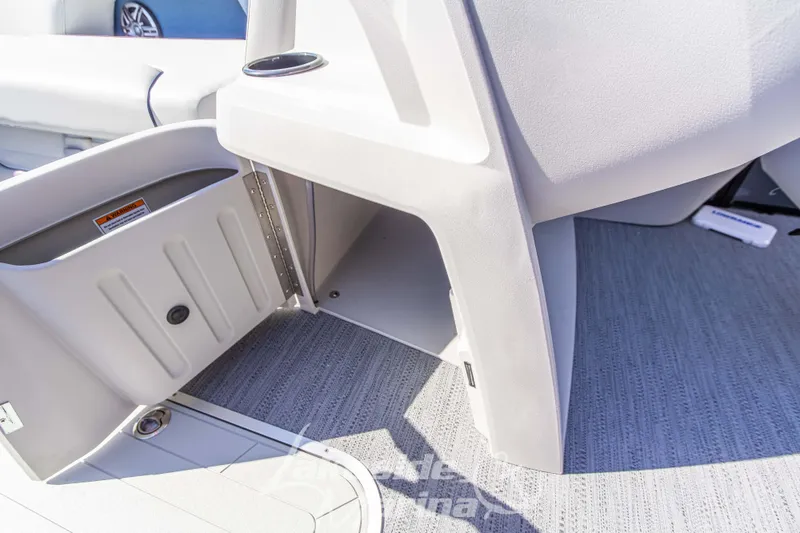 Slide: The Image of Open storage compartment on 2026 Godfrey Sweetwater 2286 SB boat, featuring gray interior. - 10
