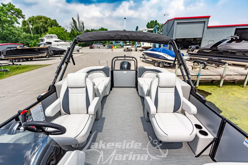 Slide: The Image of 2026 Godfrey Sweetwater 2286 SBC pontoon boat at marina, featuring luxurious seating. - 9