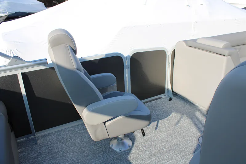 Slide: The Image of 2026 Premier 230 Sunsation RF CL boat interior with gray seating and carpeted floor. - 12