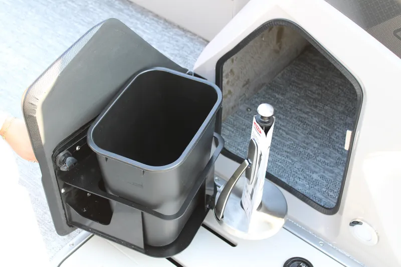 Slide: The Image of Storage compartment and trash bin on 2026 Premier 230 Sunsation RF CL boat. - 16