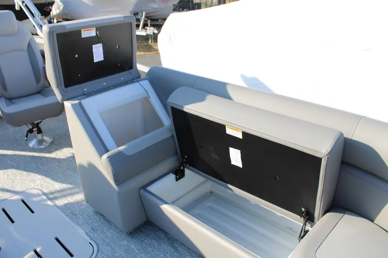Slide: The Image of 2026 Premier 230 Sunsation RF CL boat with open storage compartments and gray seating. - 18
