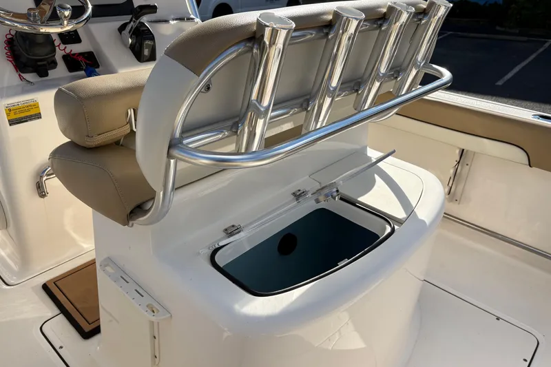 Slide: The Image of 2020 Pioneer 222 Sportfish boat interior with rod holders and storage compartment. - 11