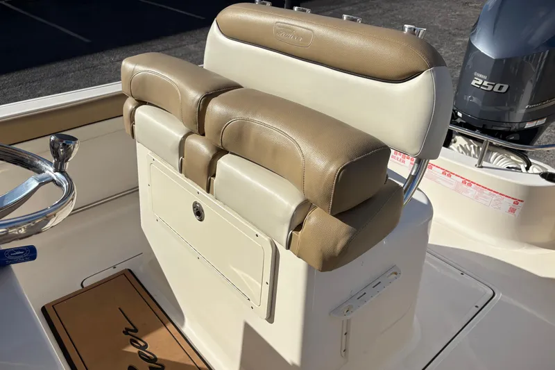 Slide: The Image of 2020 Pioneer 222 Sportfish boat seat with tan upholstery and Yamaha 250 engine. - 12