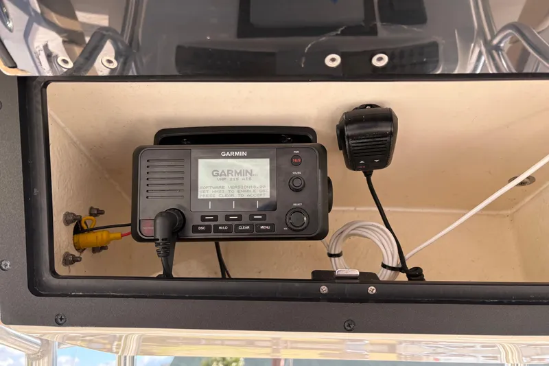 Slide: The Image of Garmin VHF radio installed on 2020 Pioneer 222 Sportfish boat dashboard. - 15