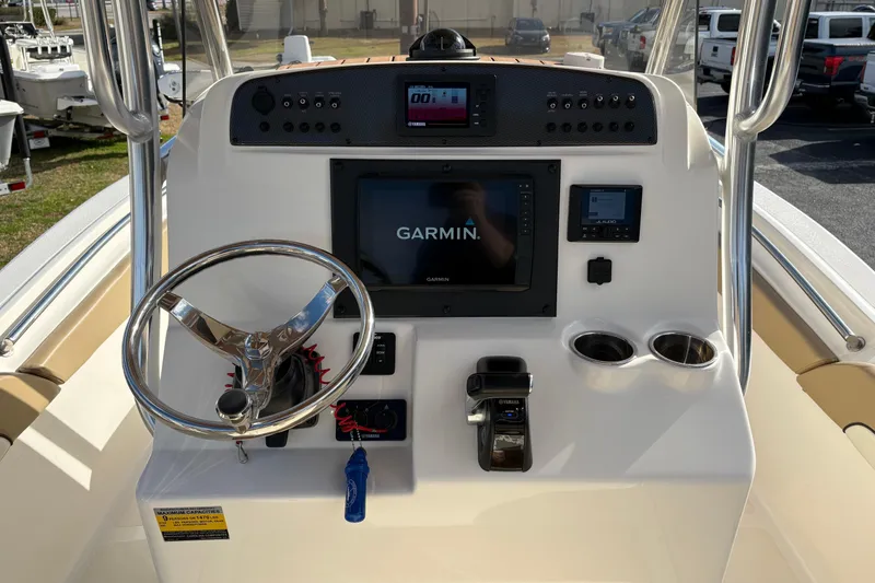 Slide: The Image of 2020 Pioneer 222 Sportfish boat console with Garmin display and steering wheel. - 16