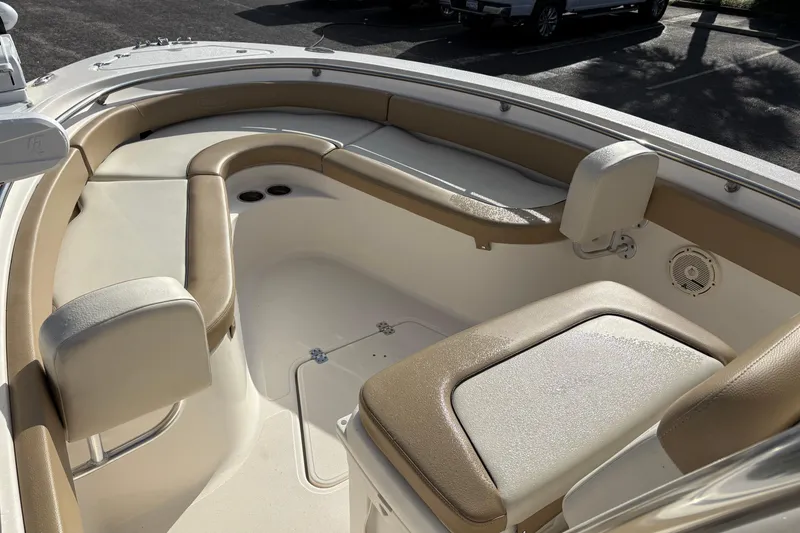 Slide: The Image of 2020 Pioneer 222 Sportfish boat interior with cushioned seating and storage compartments. - 24