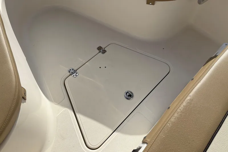 Slide: The Image of 2020 Pioneer 222 Sportfish boat deck with storage compartment and beige seating. - 25