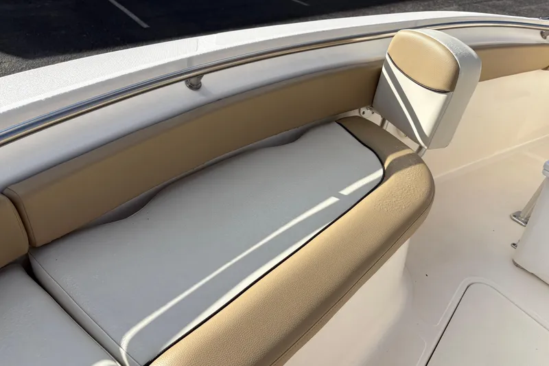 Slide: The Image of 2020 Pioneer 222 Sportfish boat interior seating with beige and white cushions. - 29