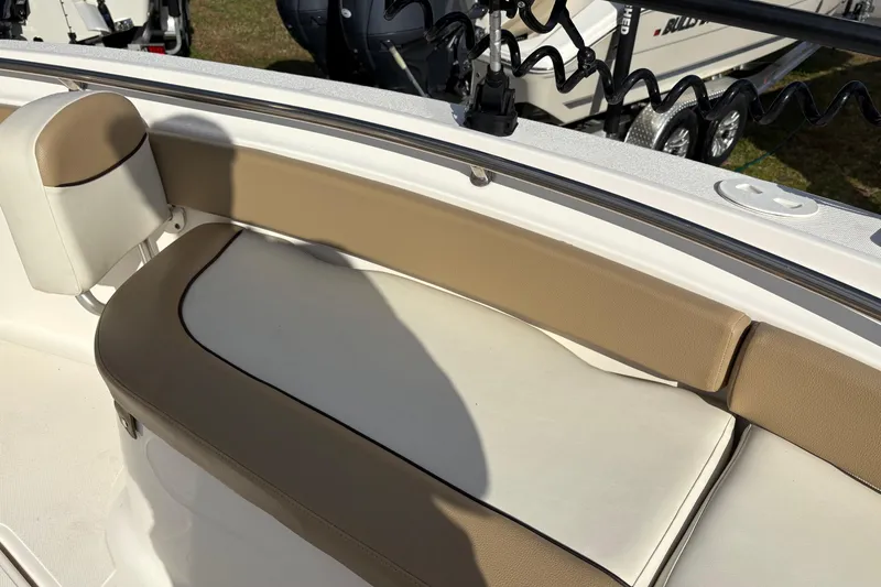 Slide: The Image of 2020 Pioneer 222 Sportfish boat with tan and white seating area. - 30