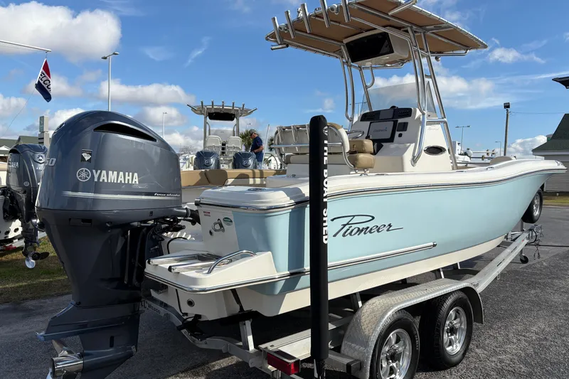 Slide: The Image of 2020 Pioneer 222 Sportfish boat with Yamaha engine on trailer, under clear blue sky. - 4