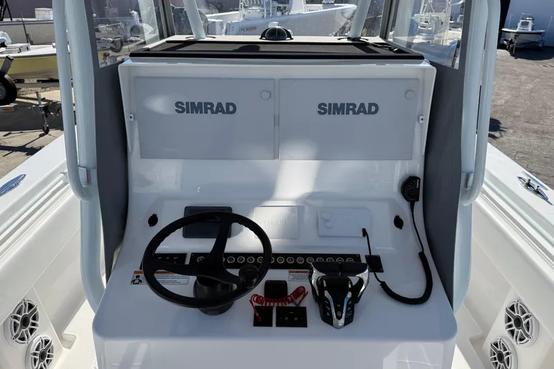 Slide: The Image of 2024 Contender 30 ST boat console with Simrad electronics and steering wheel. - 10
