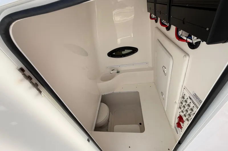 Slide: The Image of 2024 Contender 30 ST boat interior with compact bathroom and control panel. - 12