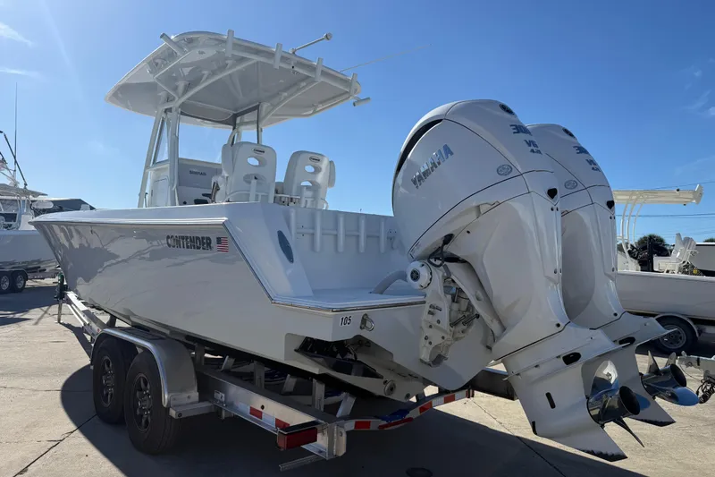 Slide: The Image of 2024 Contender 30 ST boat with dual Yamaha engines on trailer, sunny day. - 16