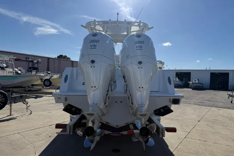 Slide: The Image of 2024 Contender 30 ST boat with dual 300 V6 engines, docked outdoors. - 17