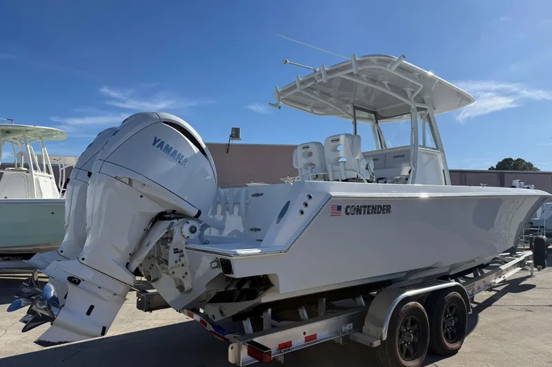 Slide: The Image of 2024 Contender 30 ST boat with Yamaha outboard engines on a trailer. - 18