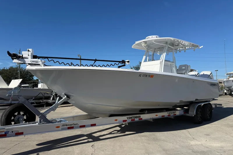 Slide: The Image of 2024 Contender 30 ST boat on trailer under clear blue sky. - 20