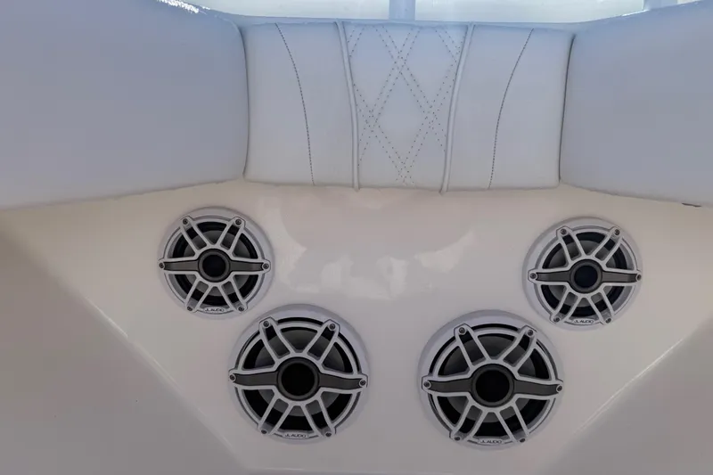 Slide: The Image of 2024 Contender 30 ST boat interior with JL Audio speakers and white cushioned seating. - 7
