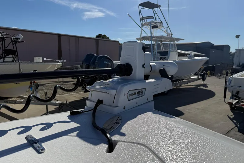 Slide: The Image of 2024 Contender 30 ST boat with Minn Kota trolling motor in a marina setting. - 8